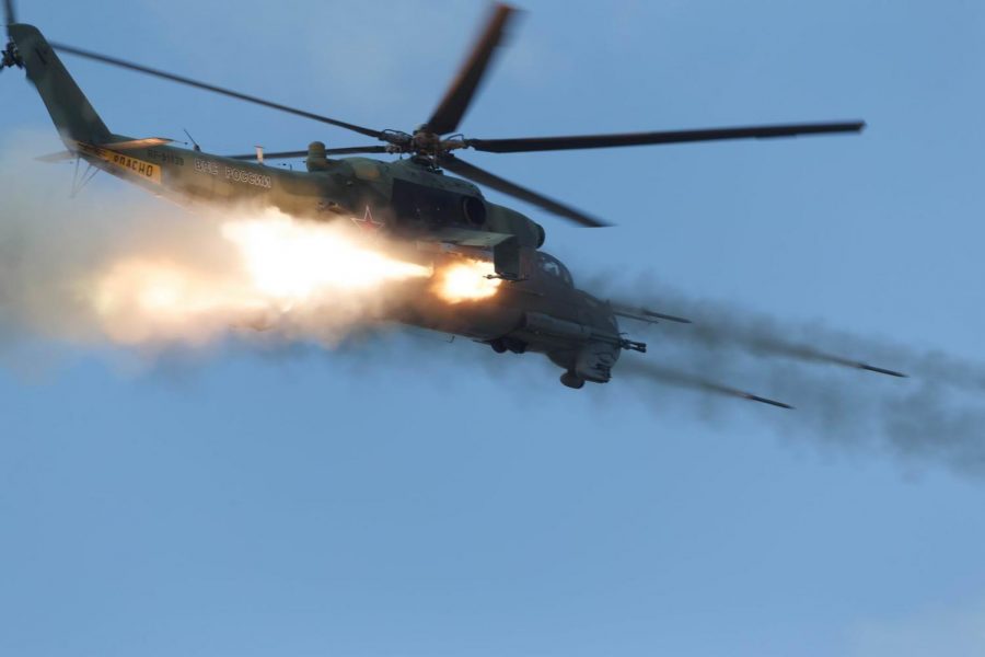 A Russian Mi-24 Gunship launches a spray of rockets during an air to ground exercise