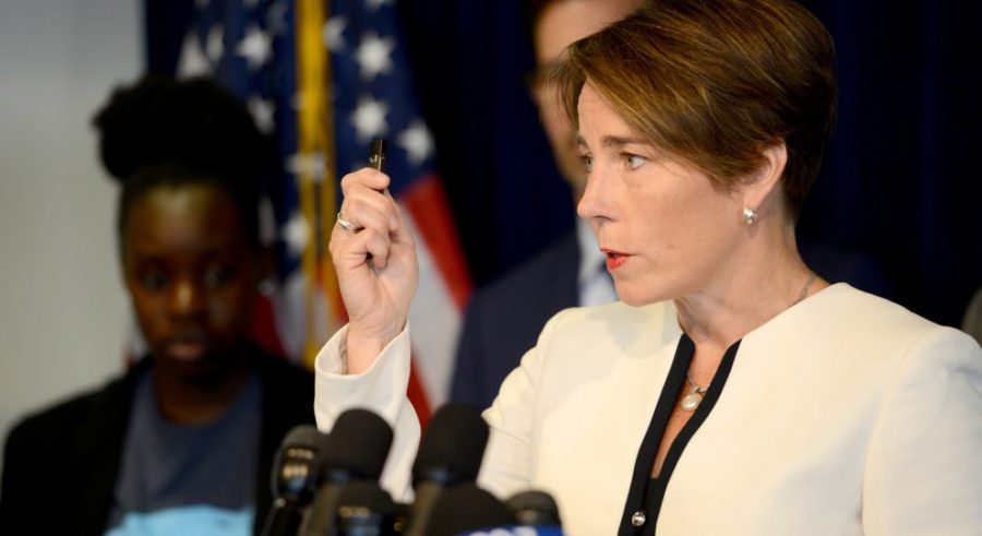 Massachusetts Attorney General Maura Healey holds up an example of the popular e-cigarette