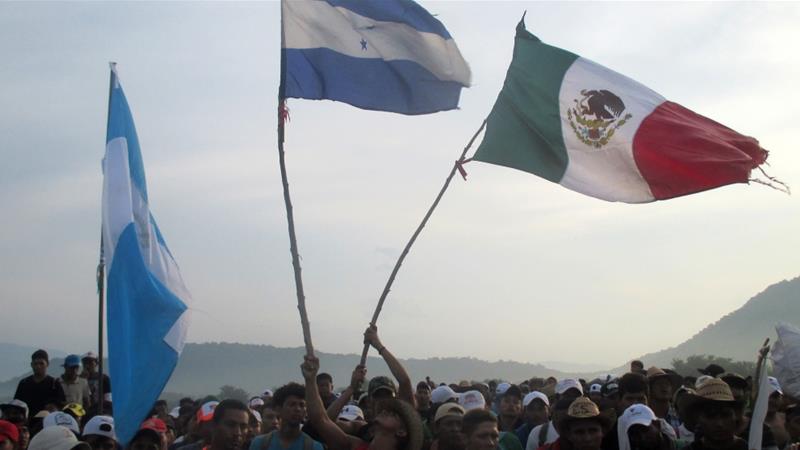 The Honduras and Mexican flag as two parts of the caravan merge