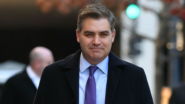 CNN reporter Jim Acosta walking out of the White House press conference