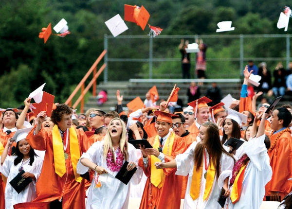 Woodside graduates wear orange and white robes.
Credit:  The Almanac