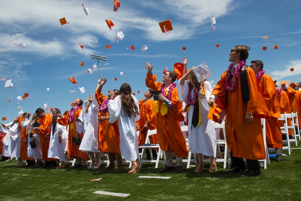 Traditionally, Woodsides female graduates wear white while male graduates wear orange.