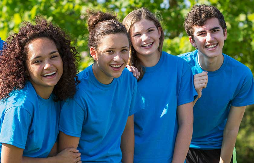 A collection of teenagers who are all dressed the same.