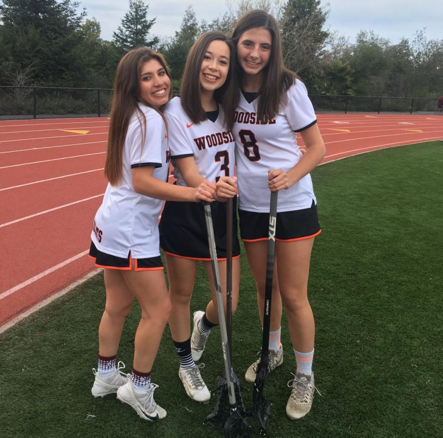 Three out of four of the varsity team captains of Woodside High girls lacrosse.