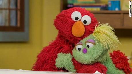 Newest Muppet, Karli, and Elmo embrace on internet-only video.