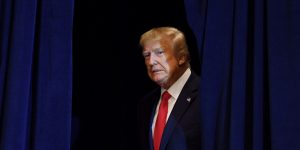 President Donald Trump prepares to walk into a press conference.