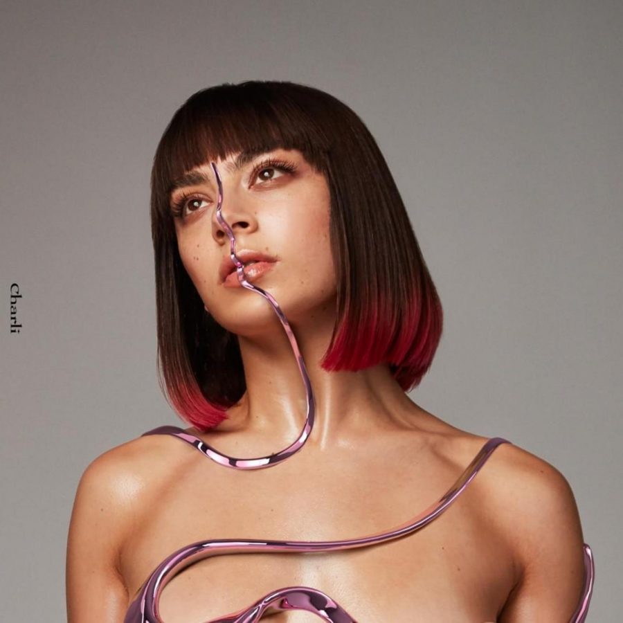 Charli XCX poses on the cover of Charli draped in futuristic tendrils designed by 3d makeup creator Ines Alpha.