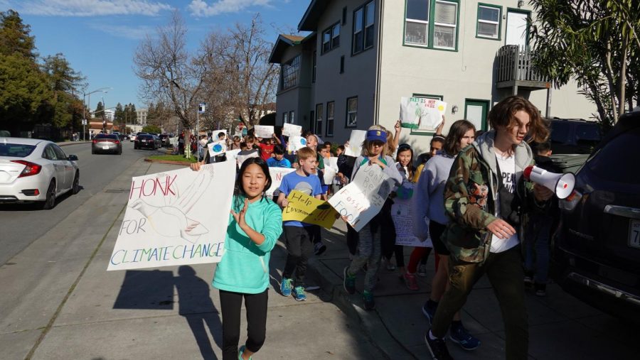 Natalie Su waved a sign that said Honk For Climate Change, encouraging cars to honk and show their support for the strike.