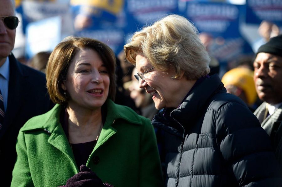 Amy Klobuchar (left) and Elizabeth Warren (right) spoke together before lining up in the Martin Luther King Jr. Day march in Columbia, South Carolina.