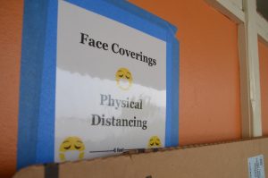 Announcement at Woodside High School promoting mask and social distancing.