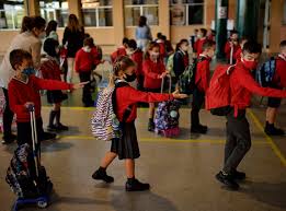 Students in Spain social distance and wear masks as they resume in-person school.