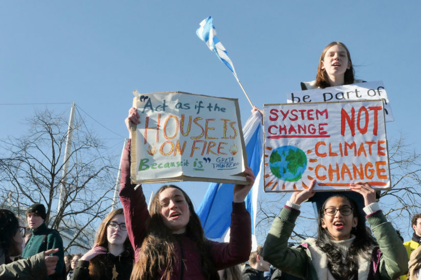 Teenagers protest in a climate stirke asking voters to think about the climate.