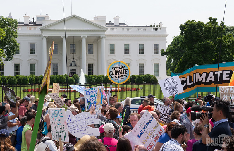 Climate justice protesters outside the White House at a protest in April 2017. Over three years later, climate change is more of an issue than ever.
