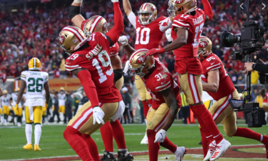 The forty-niner offense celbrates by spiking the ball on the ground after scoring a touchdown.