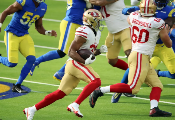 49er running back Raheem Mostert charges ahead  against the L.A. Rams, a divisional rival.
