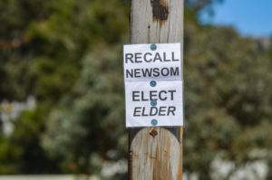 A sign advocating for the recall of Gavin Newsom and the election of front-runner Larry Elder hangs along Highway 1 just outside of Half Moon Bay, California on Monday, September 6, 2021. Voters will be deciding on September 14 whether Newsom will retain his seat in office in an election that has been heavily politicized. 