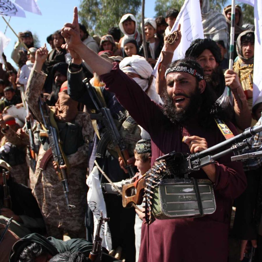 Afghan Taliban fighters and villagers attend a gathering as they celebrate the peace deal signed between the U.S. and the Taliban.