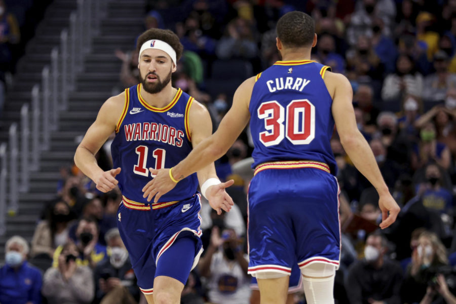 Golden State Warriors guard Klay Thompson (11) is congratulated by guard Stephen Curry (30) after Thompson scored against the Detroit Pistons during the first half of an NBA basketball game in San Francisco, Tuesday, Jan. 18, 2022.