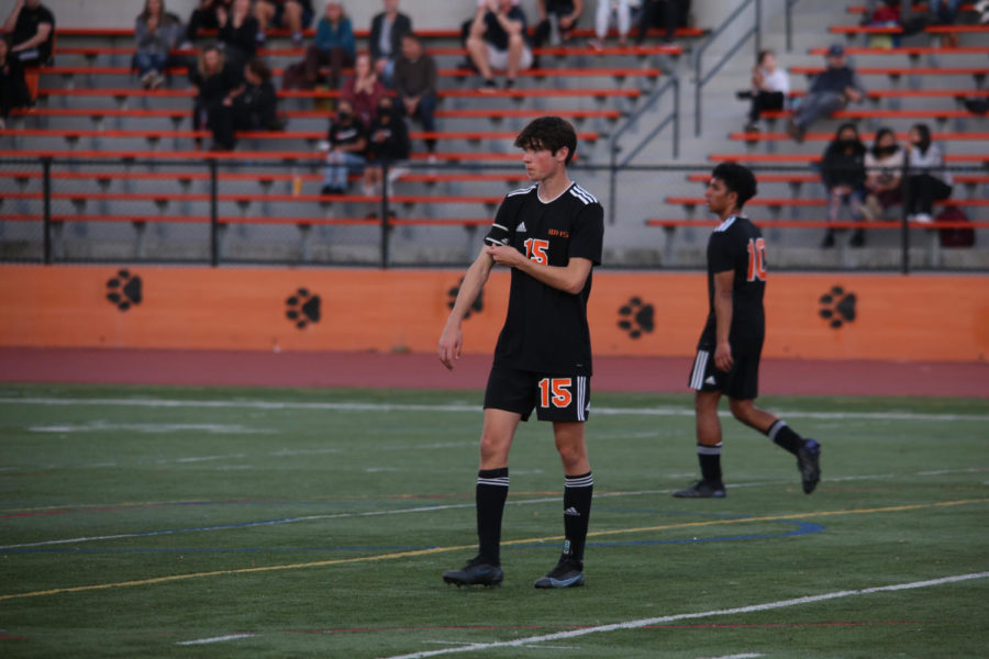 Junior Benny Bogyo (15) and senior Diego Ruiz (10) look on during a recent Woodside home game against M-A. Despite a fantastic playoff run, Woodside ultimately lost to Archbishop Mitty in Saturdays hard-fought final