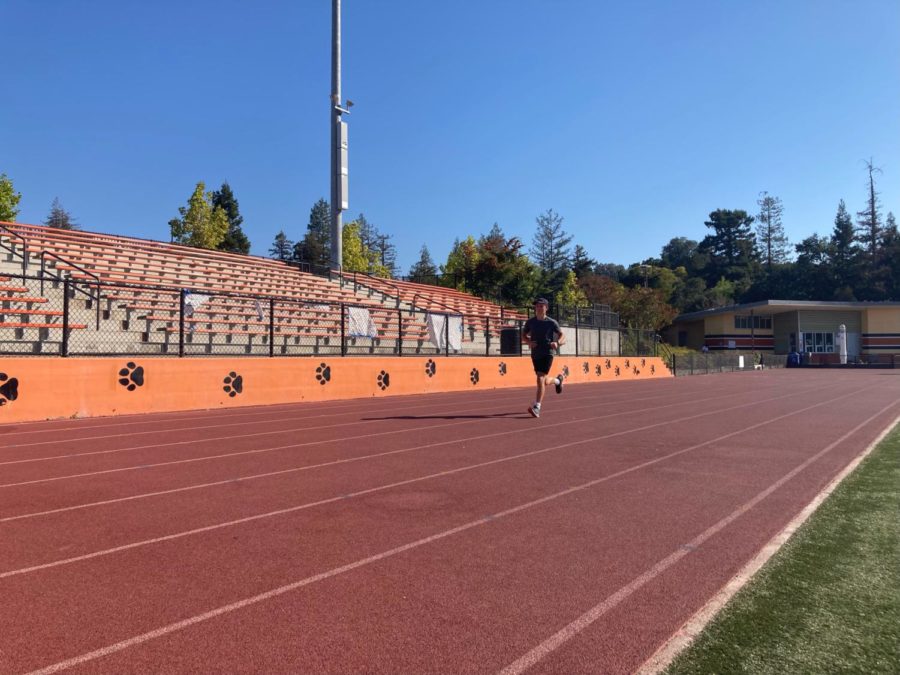 Varsity runner Dominic Barty warms up at practice. While no races have occurred yet for Woodside cross country, players are making sure to maintain their abilities.