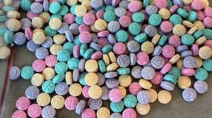 Rainbow fentanyl takes many forms, often appearing as small candy-shaped pills or sidewalk chalk. 