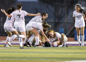 Last year’s 2021 varsity girl’s soccer celebrates after a goal against Sequoia High school.