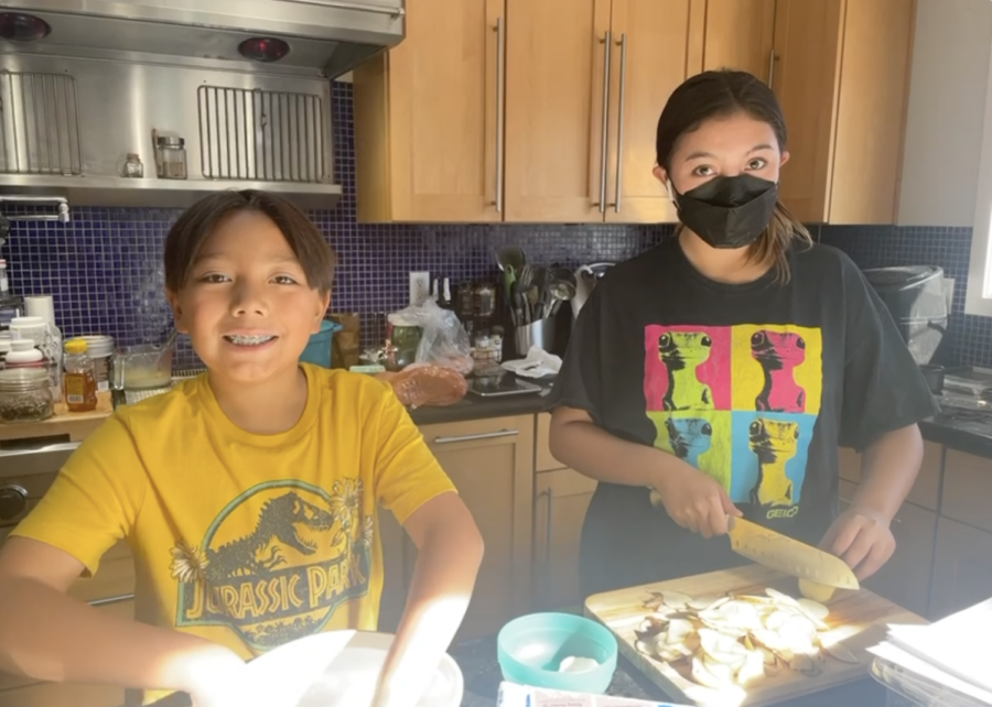 The author and her younger brother happily prepare dishes for their Thanksgiving dinner.