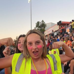 Escobar shows her school spirit at a neon themed football game. 
