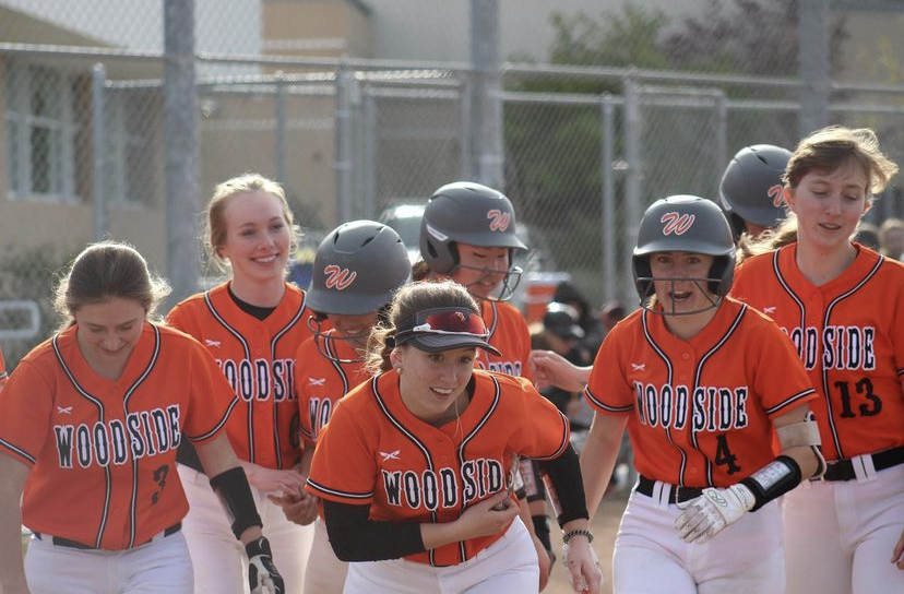 The Softball team runs out on the field with smiles on their faces after varsity beat Aragon 12-2!