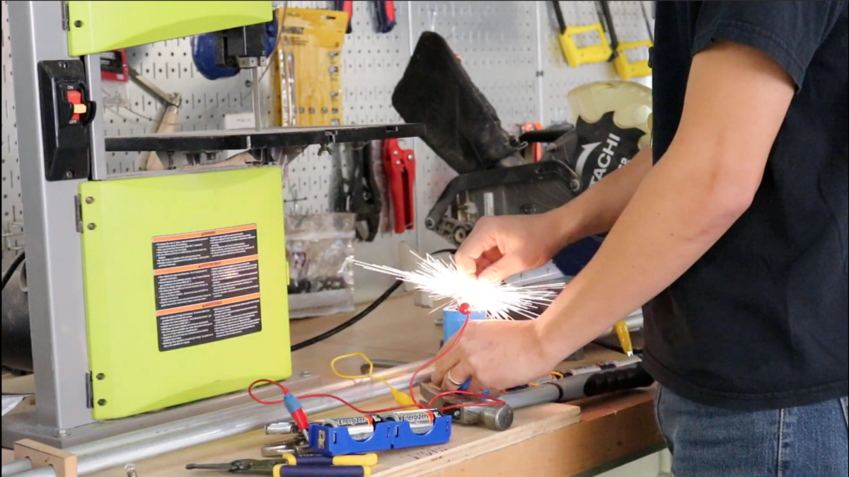 AP Physics C: Electricity and Magnetism teacher Matthew Sahagún performs an experiment in his classroom.