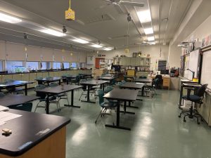 Ighanian, the human biology and biology teacher, waves from her freshman biology classroom.