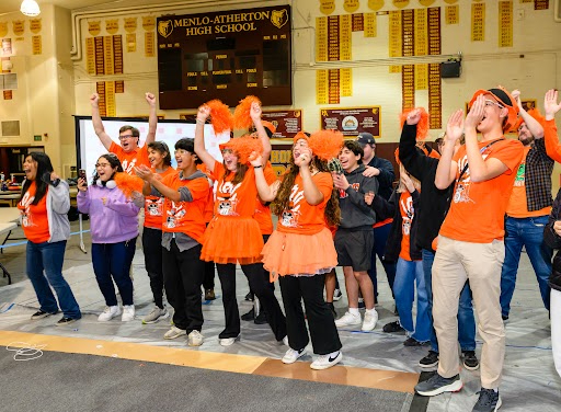 Robotics team members cheer for their teams at the Mechanical M -Ayhem! 