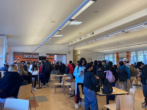 Students waiting in line for cafeteria food to get their brunch.

