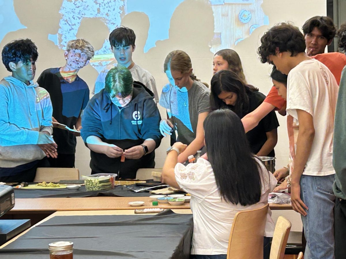 Ms. van Putten teaches club members how to make sushi during an AAPI Club meeting.