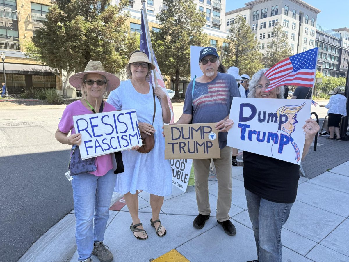 Protesters rally along El Camino Real on Sept. 1 against President Trump and his policies.