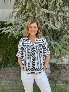Photo taken of Amy Hanson in a nature filled background.