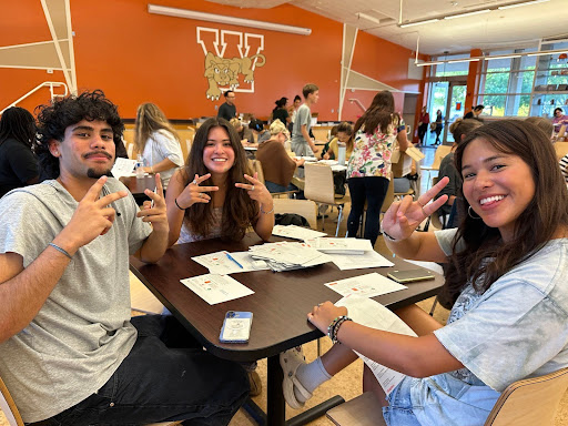 Colin Ulrich, Olivia Bravo and Sophia Bravo volunteering at Brochure Night for the Woodside Foundation.