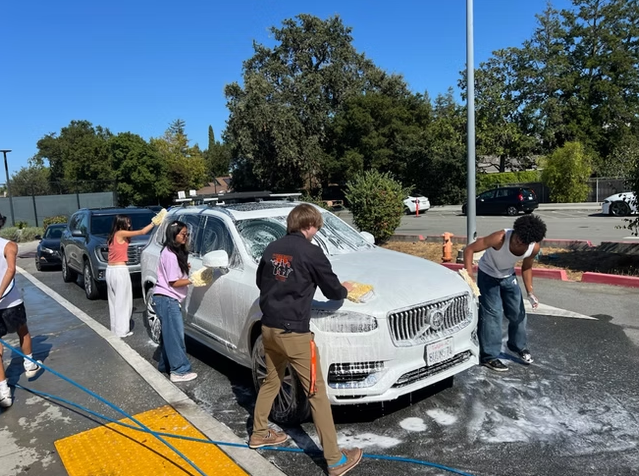 Students at the car wash fundraiser, one of the many run by the music program, on Sep. 20.
