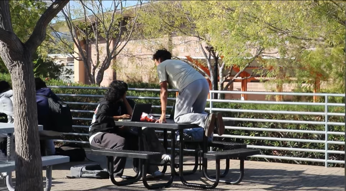 Senior Andrew Ortiz on a table begging for a freshman's phone number