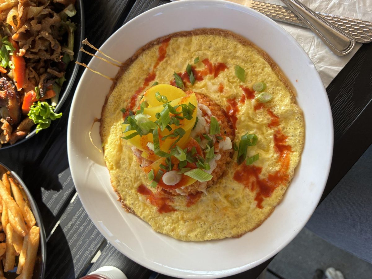 Colorful kimchi fried rice dish with egg and fresh scallions.