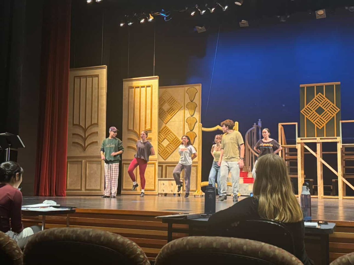 Cast members of the musical during tech week preparing for opening night.