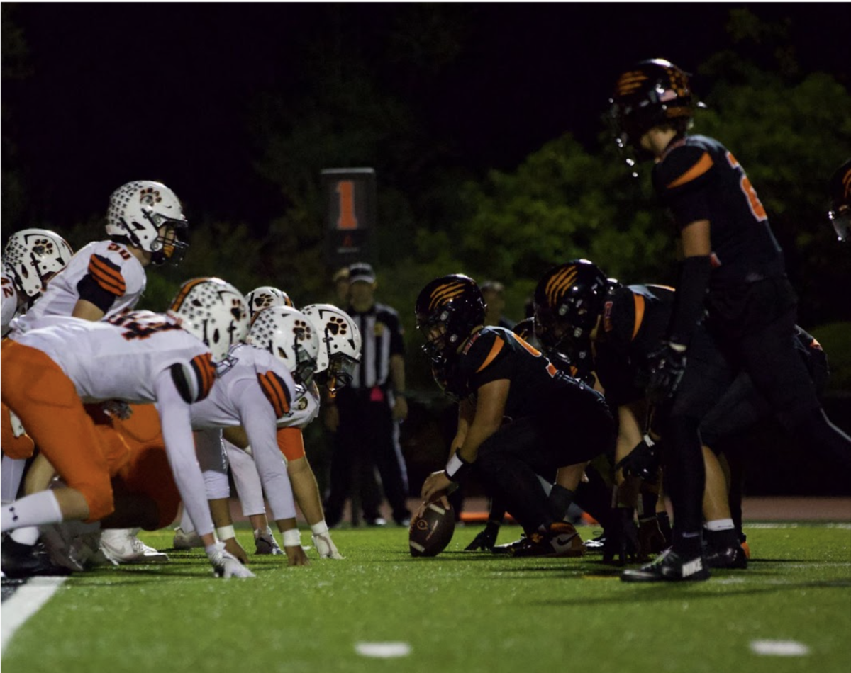 The Woodside football team lined up against rival Half Moon Bay.